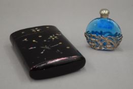 A lacquered cigar case and a scent bottle. The former 12 cm high.