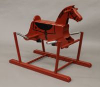 A vintage red painted rocking horse. 74 cm high.