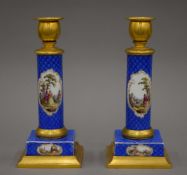 A pair of 19th century Continental ormolu mounted painted porcelain candlesticks, possibly Dresden.