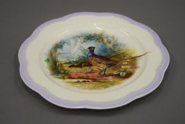 A Wedgwood painted porcelain plate decorated with pheasants. 23 cm diameter.