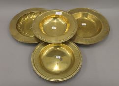 Four brass offertory plates. The largest 30.5 cm diameter.