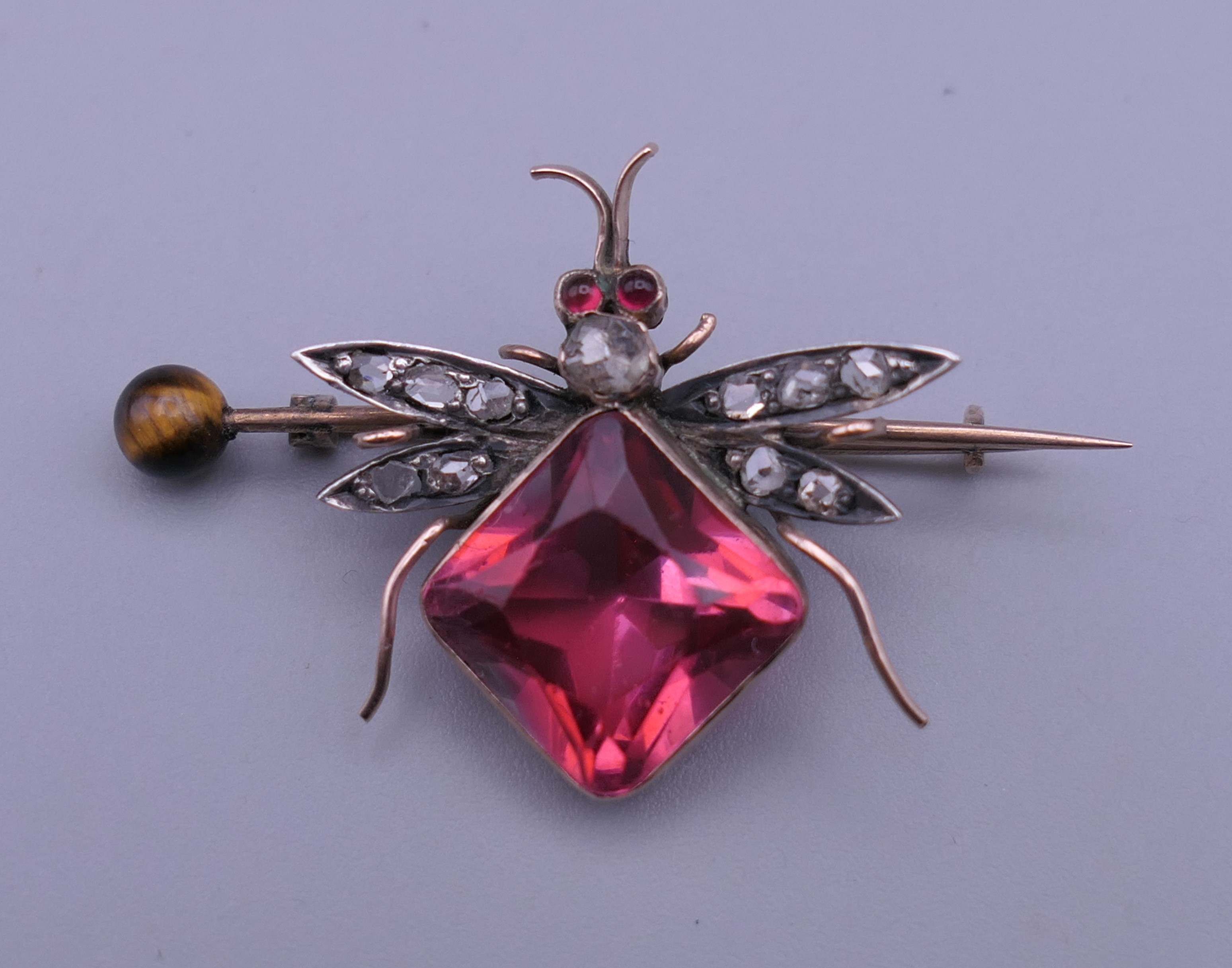 An unmarked gold diamond set bee brooch. 4 cm wide.