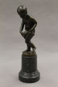 A 19th century patinated bronze sculpture of a boy carrying a bag of letters,