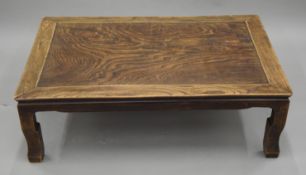 A Chinese elm low coffee table. 99 cm long.