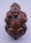 A 19th century carved coquilla nut snuff box. 7.5 cm high.