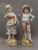 A pair of bisque porcelain figures. The largest 46 cm high.