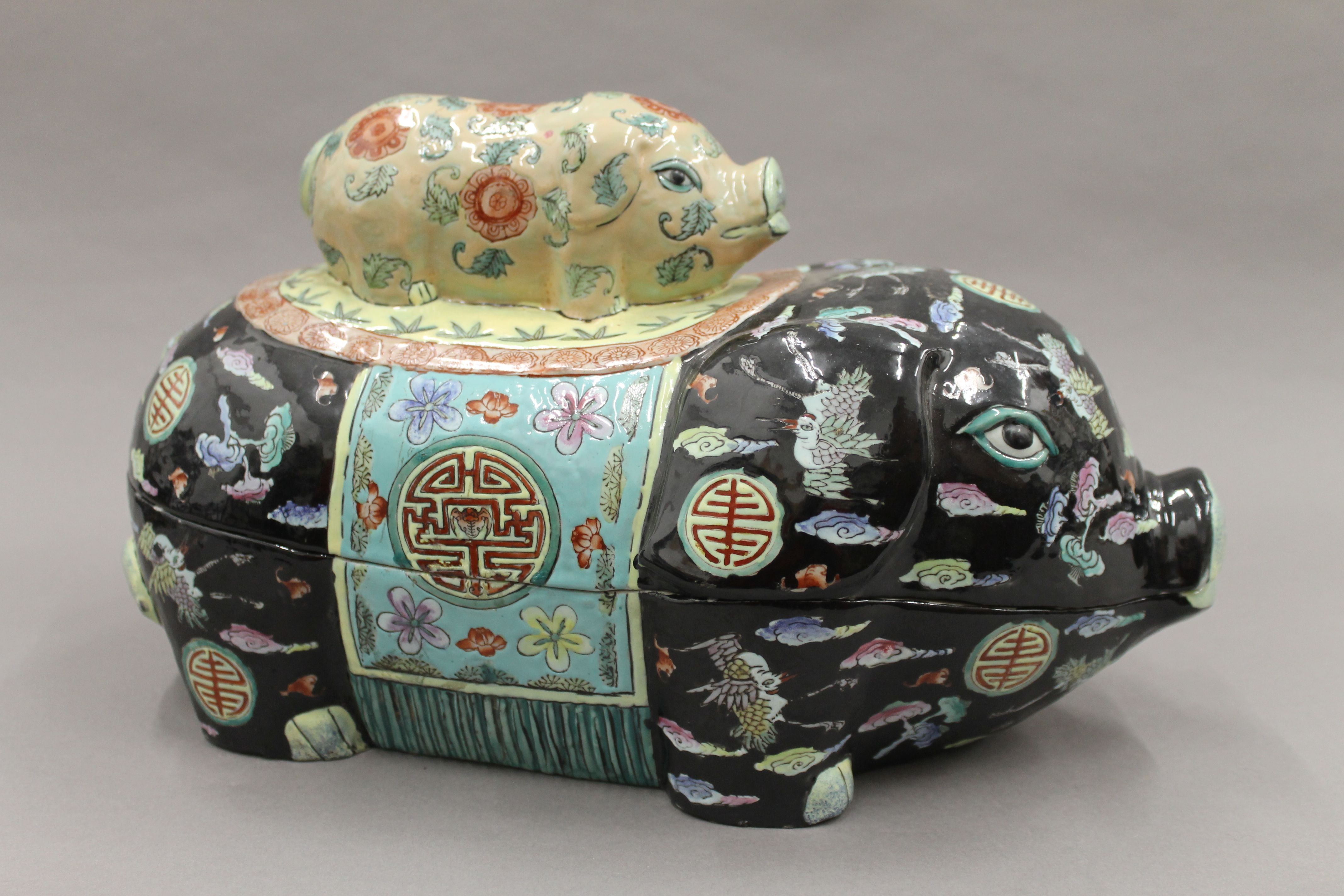 A Chinese famille noir porcelain lidded box formed as a pig. 37 cm long.