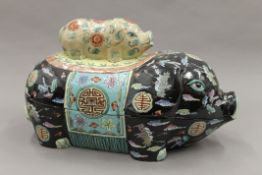 A Chinese famille noir porcelain lidded box formed as a pig. 37 cm long.