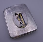 A silver cigarette case decorated with a scantily clad lady. 7 cm wide.