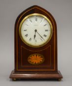 An Edwardian mantle clock with inlaid mahogany case, the enamelled dial marked Webster.