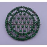 A Victorian green paste brooch. 5 cm diameter.