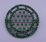 A Victorian green paste brooch. 5 cm diameter.