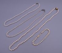 Two 9 ct gold set pearl necklaces, a 14 K gold set pearl bracelet and another pearl necklace.