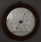 A Victorian oak cased barometer. 26 cm diameter.