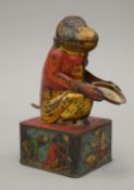 A vintage tin plate monkey form money bank. 16 cm high.