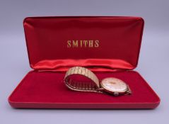 A boxed Smith's 9 ct gold cased watch on stainless steel strap.