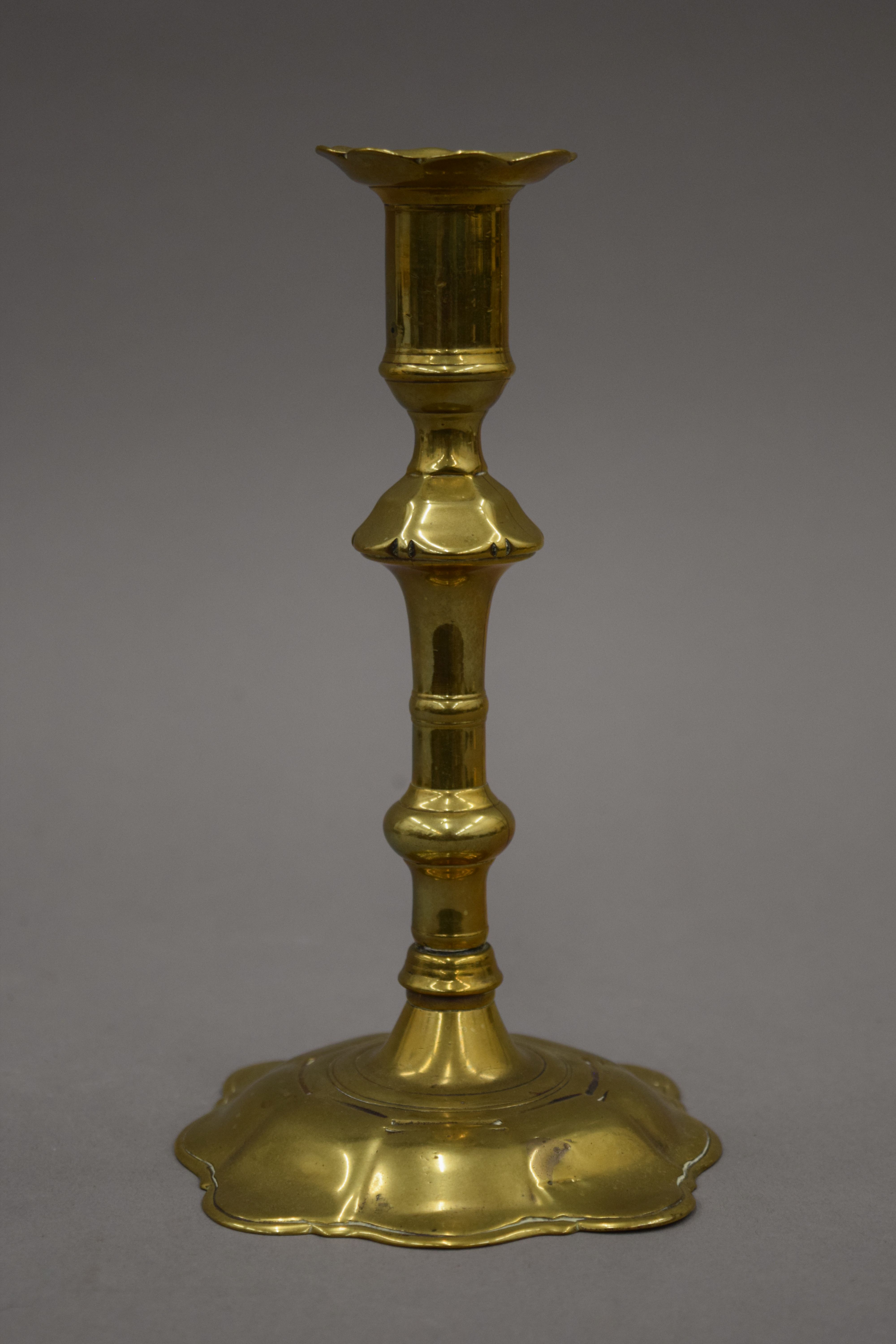 An 18th century brass candlestick with petal edge drip pan and base, - Image 7 of 9