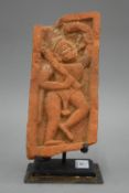 An antique Indian terracotta carving mounted on a later metal base. 26.5 cm high overall.