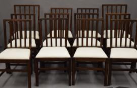 A set of twelve oak dining chairs, including two with arms,