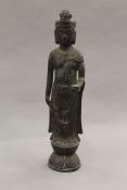 A bronze figure of Guanyin. 32.5 cm high.