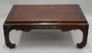 An Eastern hardwood carved coffee table. 120 cm long.