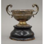 A silver twin handled trophy cup on stand. 15 cm wide. 145.7 grammes.