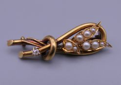 An unmarked gold diamond and pearl wheatsheaf brooch. 4.5 cm wide. 5.7 grammes total weight.