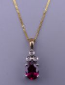 A 9 ct gold ruby and diamond pendant on a 9 ct gold chain. The pendant 1.75 cm high. 2.
