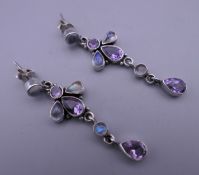 A pair of silver moonstone and amethyst earrings. 4.5 cm high.