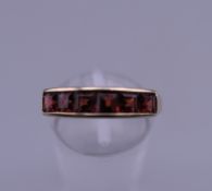 A 9 ct gold six stone garnet ring. Ring size O/P. 1.9 grammes total weight.