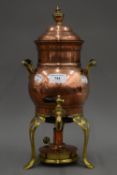 An antique copper and brass samovar with wooden handles,