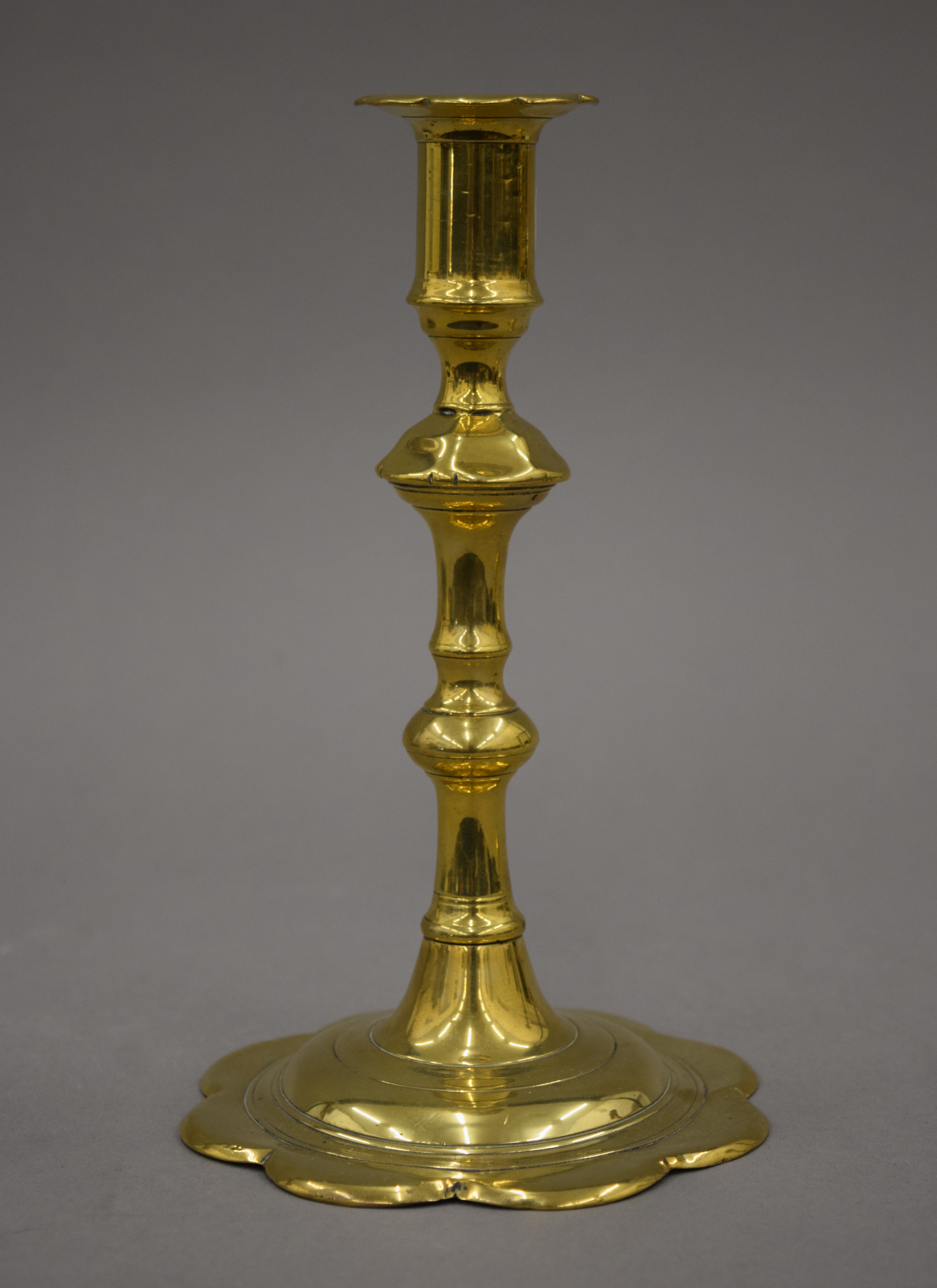 An 18th century brass candlestick with petal edge drip pan and base, - Image 3 of 9