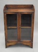 A small early 20th century glazed oak bookcase. 59.5 cm wide.