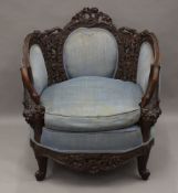 A 19th century carved settee with swan form arms, together with a matching armchair.