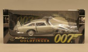 A boxed Autoart James Bond Collection Goldfinger Aston Martin. The box 36.5 cm wide.