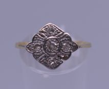 A gold and platinum diamond ring. Ring size R/S. 2 grammes total weight.