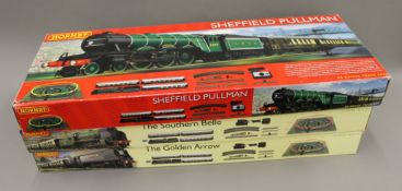 Three boxed Hornby railway sets.