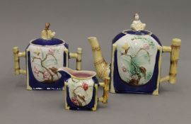 A Victorian three-piece Majolica tea set. The teapot 18 cm high.