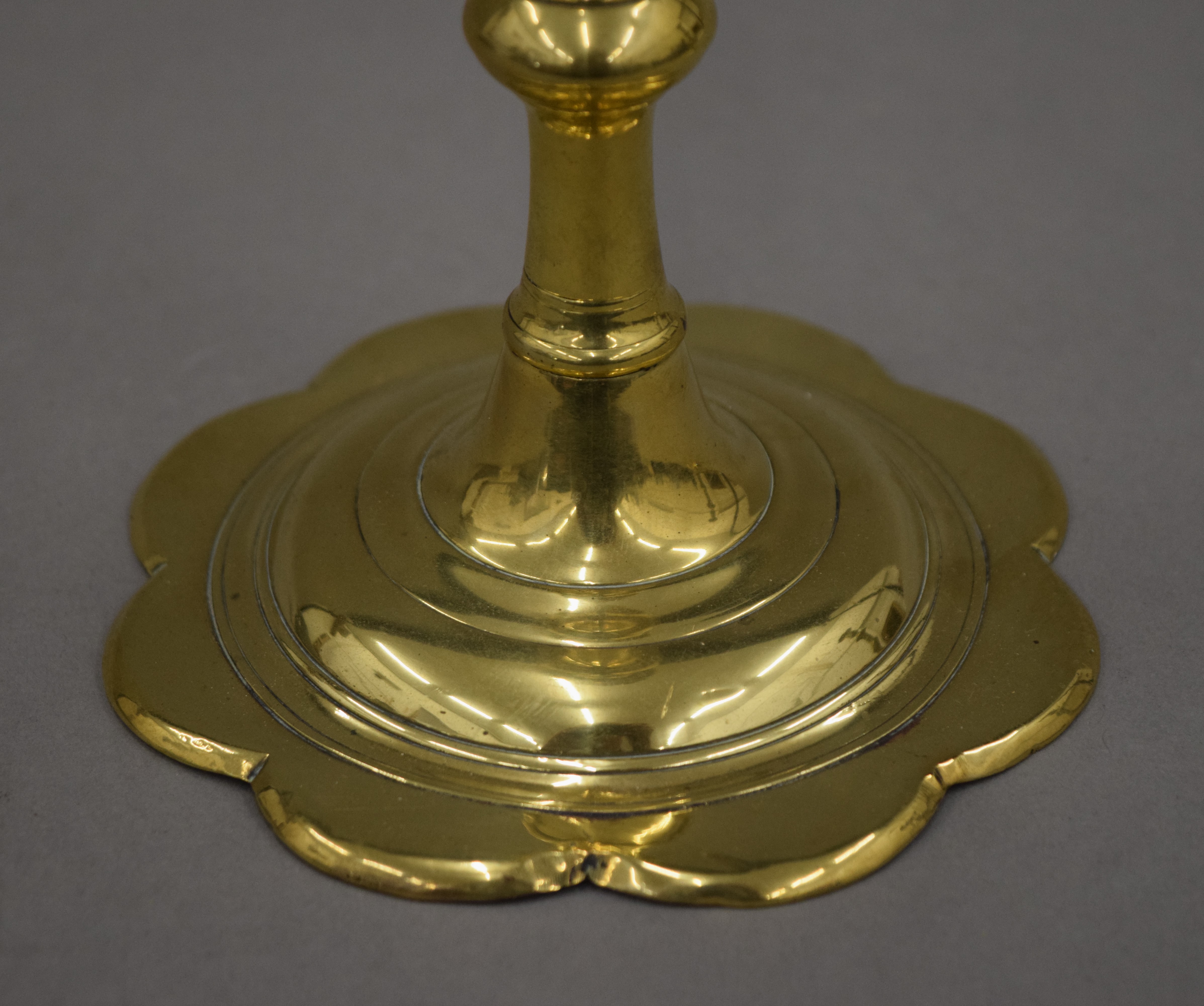 An 18th century brass candlestick with petal edge drip pan and base, - Image 5 of 9