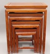 An Oriental style nest of four mahogany table.