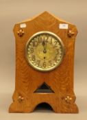 An Arts and Crafts oak mantle clock, in working order. 46.5 cm high.