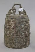 A bronze archaic style bell. 27 cm high.