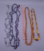 A quantity of various vintage necklaces including amber, coral, etc.