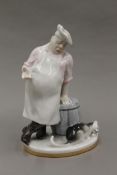 A Russian porcelain figure of a chef and a cat. 17 cm high.