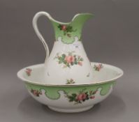 A Victorian porcelain wash jug and bowl decorated with roses.