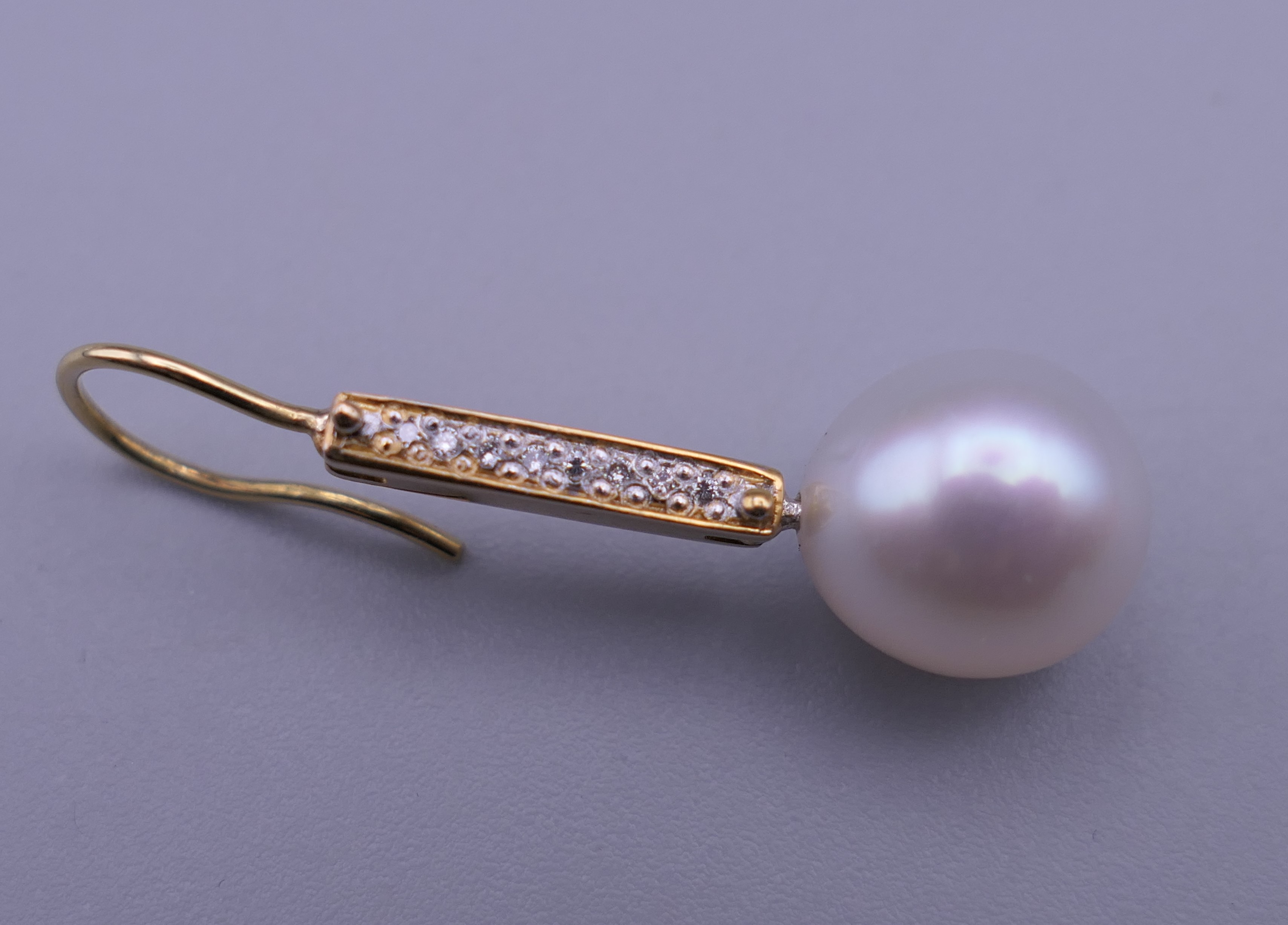 A pair of unmarked 18 K gold diamond and pearl earrings. 3.25 cm high. - Image 2 of 5