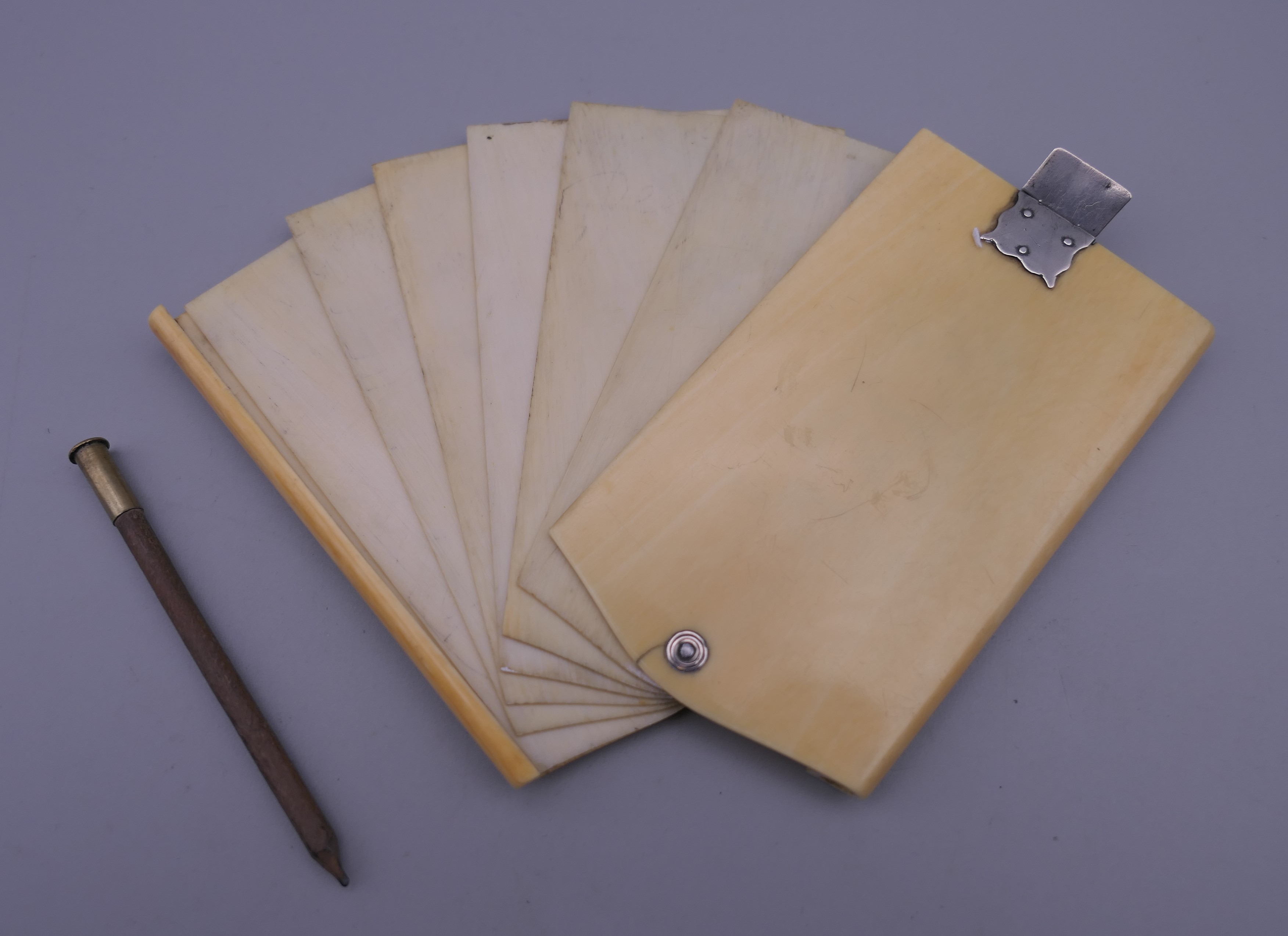 A 19th century ivory aide memoire fitted with six interior leaves, with unmarked silver fittings. 9. - Image 3 of 8