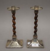 A pair of Arts and Crafts silver and oak barley twist candlesticks. 23 cm high.