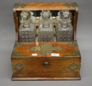 A Victorian oak silver plate mounted tantalus. 35 cm wide.