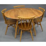A blonde Ercol table and chairs. The table 112 cm long.